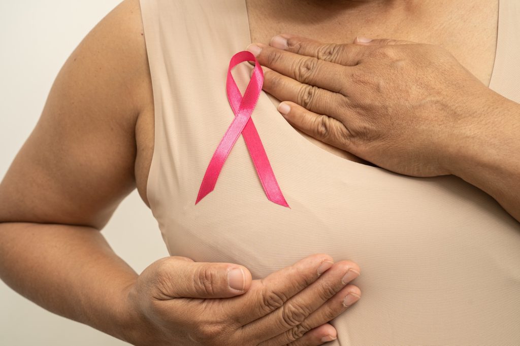 Breast cancer, pink ribbon at Asian senior lady for supporting awareness, World Breast Cancer Day.